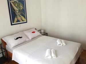 a bedroom with a white bed with towels on it at Apartment 4 you in Split