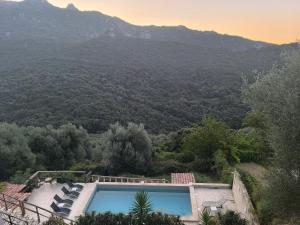 a swimming pool with a view of a mountain at Casa Stella in Olmeto