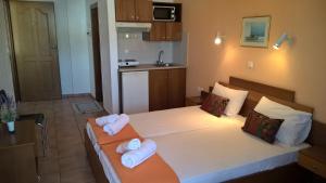 a bedroom with two beds with towels on them at Muses in Neos Marmaras