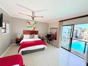 a bedroom with a bed and a pool at Le Blue Guesthouse in Port Elizabeth +60 photos