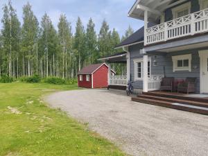 a house with a red shed next to a driveway at Dream house in Savonlinna