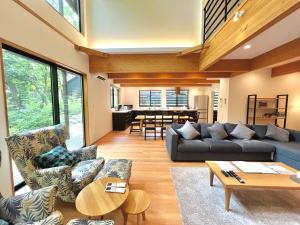 a living room with a couch and a table at Akamatsu House in Hakuba