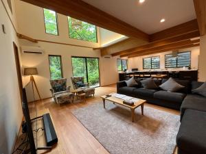 a living room with a couch and a table at Akamatsu House in Hakuba