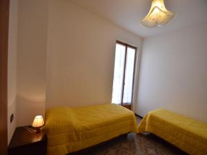 a bedroom with two beds and a window at Spacious Retreat in Cannero in Cannero Riviera