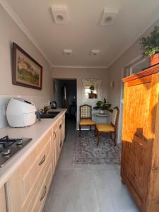 a kitchen with a sink and a counter top at Cosy Cottage Greenside in Johannesburg