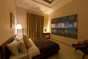 a bedroom with a bed and a large screen at Mây Hoa Tiên Villa - House in Da Lat