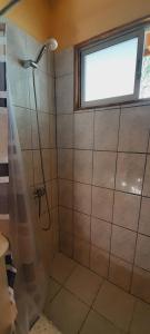 a shower in a bathroom with a window at Cabañas Los Sauzales del Elqui in Pisco Elqui +26 photos