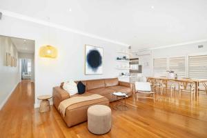 a living room with a couch and a table at Beach-Front Apartments in Sydney +20 photos
