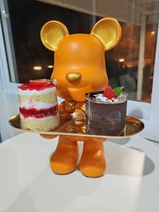 two plates of desserts on a plate with an animal at The Triple Little House in Ban Nong Chang Nua