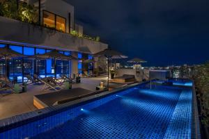a swimming pool on top of a building at night at Southwest Grand Hotel in Naha