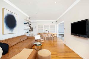 a living room with a couch and a table at Beach-Front Apartments in Sydney