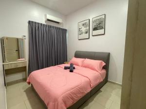 a bedroom with a bed with a pink blanket at Pangkor Villa 16 Homestay 4Rooms 3Bathroom Free WIFI & Karaoke in Pangkor