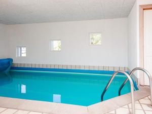 a swimming pool with blue water in a room at Luxury Retreat with Pool - By Traum Ferienwohnungen in Ho +57 photos