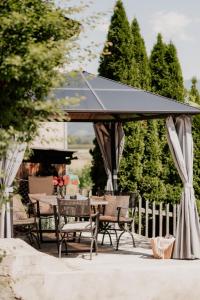 a table and chairs under a large umbrella at Ferienhaus Elisabeth Spielberg in Spielberg
