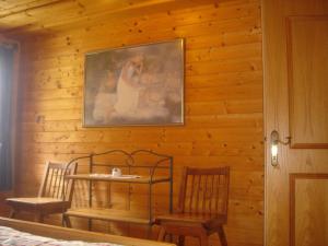 a wooden wall with a table and two chairs at Chalet in Kolbnitz near Ski Slopes in Penk +14 photos