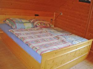 a large wooden bed in a wooden room at Chalet in Kolbnitz near Ski Slopes in Penk