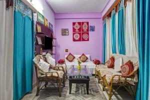 a dining room with purple walls and a table and chairs at Hill View 2BHK Homestay with Garden - 2 Bedrooms with Living room Kitchen and 2 Washrooms in Nainital