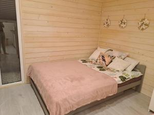 a bedroom with a bed in a wooden room at Domek na Żółtańcach in Żółtańce