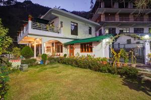 a house with a lawn in front of it at Hill View 2BHK Homestay with Garden - 2 Bedrooms with Living room Kitchen and 2 Washrooms in Nainital
