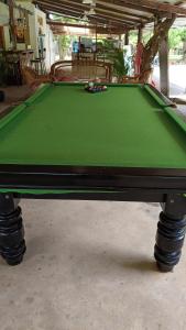 a green pool table sitting in a garage at Surya Kep - Le Soleil Kep in Kep