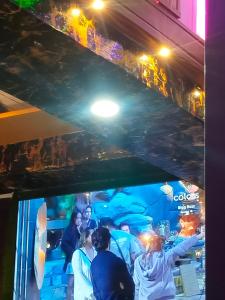 a group of people standing in front of a tv at Maa Vaishno Guest House in Varanasi