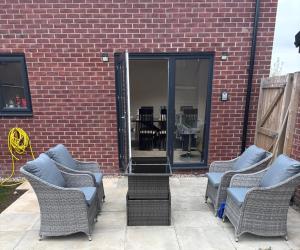 a group of chairs sitting in front of a brick building at Guest Village in Hull