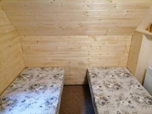 a room with two beds in a wooden room at Chata Roubenka in Jedovnice +13 photos