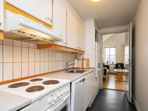 a kitchen with a stove and a sink at 6 person holiday home in Rudkøbing in Rudkøbing +49 photos