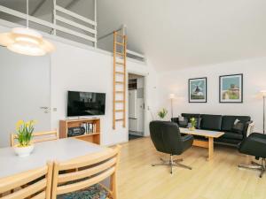 a living room with a table and chairs and a ladder at 6 person holiday home in Rudkøbing in Rudkøbing
