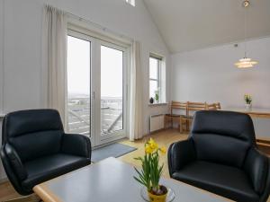 a living room with two chairs and a table at 6 person holiday home in Rudkøbing in Rudkøbing