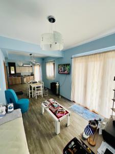 a living room with a couch and a table at Villa Christoforos Kekakos Magical View in Neapolis