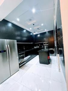 a kitchen with stainless steel appliances and black walls at Ifemide Estates - Luxury Homes in Akure