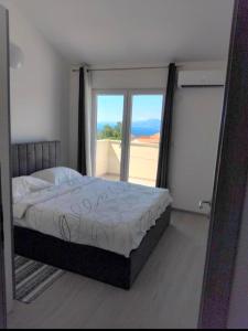 a bedroom with a bed and a large window at Apartment Tanya with jacuzzi in Rijeka +47 photos