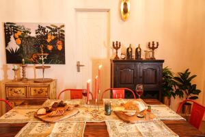 a dining room with a table with candles on it at Timber Luxe Atelier in Jaipur