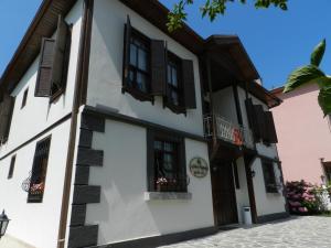 un edificio blanco con ventanas de contraventanas negras en Aslibey Konaği - Adults Only, en Sapanca