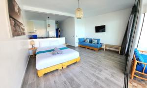 a bedroom with a bed and a blue couch at Aloha Imsouane vue sur mer in Imsouane