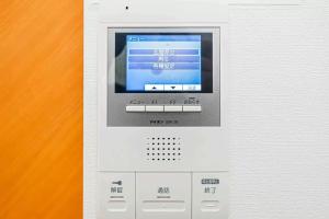 an electronic machine with a screen on top of it at Akihabara Skytree Premium Apartment 201 in Tokyo
