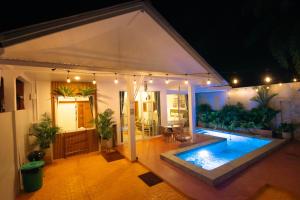 a swimming pool in the middle of a house at night at Baan Pa Palm in Ao Nang Beach