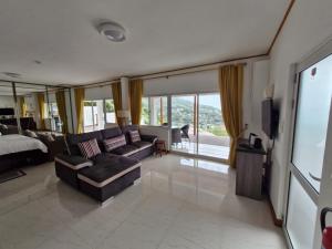 a living room with a couch and a bed at Bel Air Holiday Apartments in Victoria