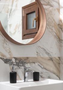 a bathroom with a sink and a mirror at Irene's House Kalamitsi in Kalamitsi +49 photos