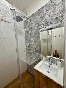 a bathroom with a sink and a shower at Ravine Apartments - Parking in Brno +15 photos