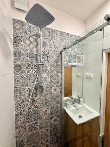 a bathroom with a shower and a sink at Ravine Apartments - Parking in Brno