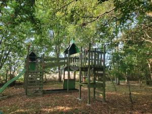 a playground with a slide in a park at Ludo'gîte in Moulhard +3 photos