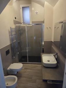 a bathroom with a shower and a toilet and a sink at Seaside Soul in Tropea