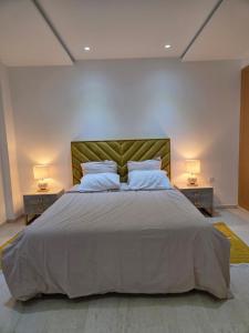 a bedroom with a large bed with two night stands at Luxurious Apartment in Sousse