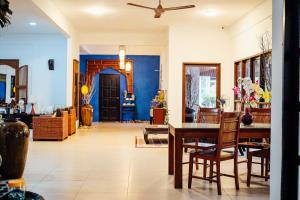 a living room with a table and chairs at Tropical Langkawi in Pantai Cenang