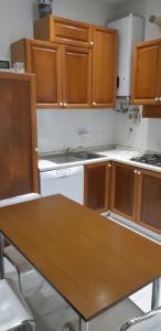 a kitchen with wooden cabinets and a wooden table at Casa Delfino in Chioggia