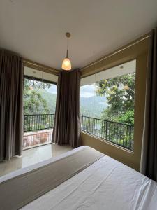 a bedroom with a bed and a large window at Ella Family House in Ella