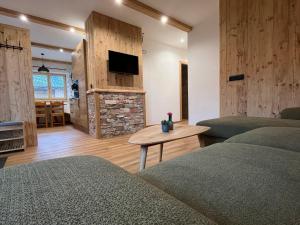 Ferienwohnung Niederbergerhof في أونكن: غرفة معيشة مع سريرين وتلفزيون بشاشة مسطحة