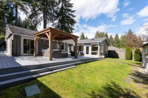 a backyard with a pergola and a house at Northern Stay in North Vancouver